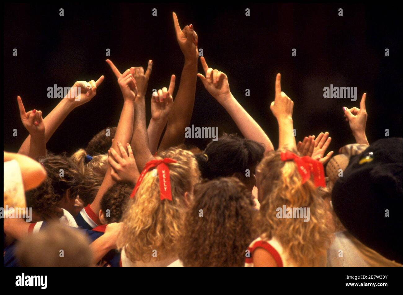 Austin Texas USA: Members of high school girls basketball team show that they're No. 1 after winning the title at the state tournament.  ©Bob Daemmrich Stock Photo