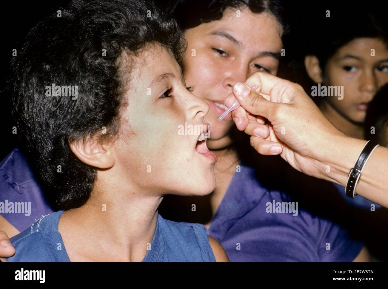 Toothpick Inoculation Elementary school student receives oral inoculation during back-to ...