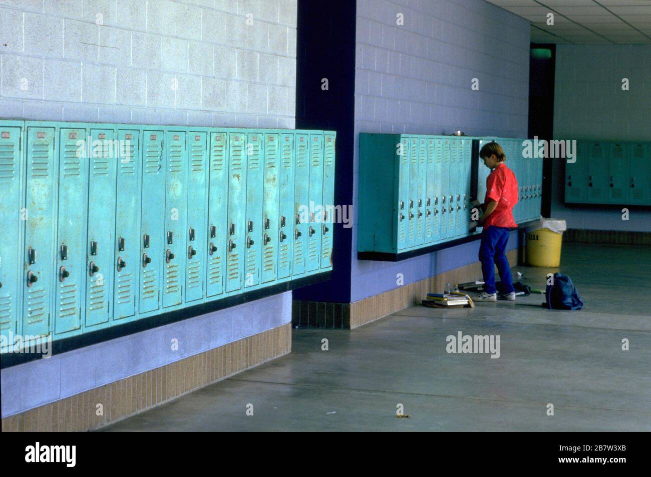 Austin, Texas USA: Junior high school student puts books in his locker between classes.      ©Bob Daemmrich Stock Photo