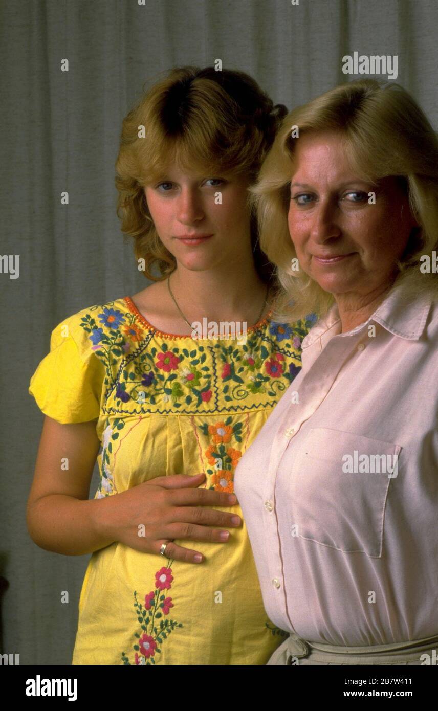 Mother poses with her pregnant 14-year-old daughter a week before the baby's due date.   MR   ©Bob Daemmrich Stock Photo