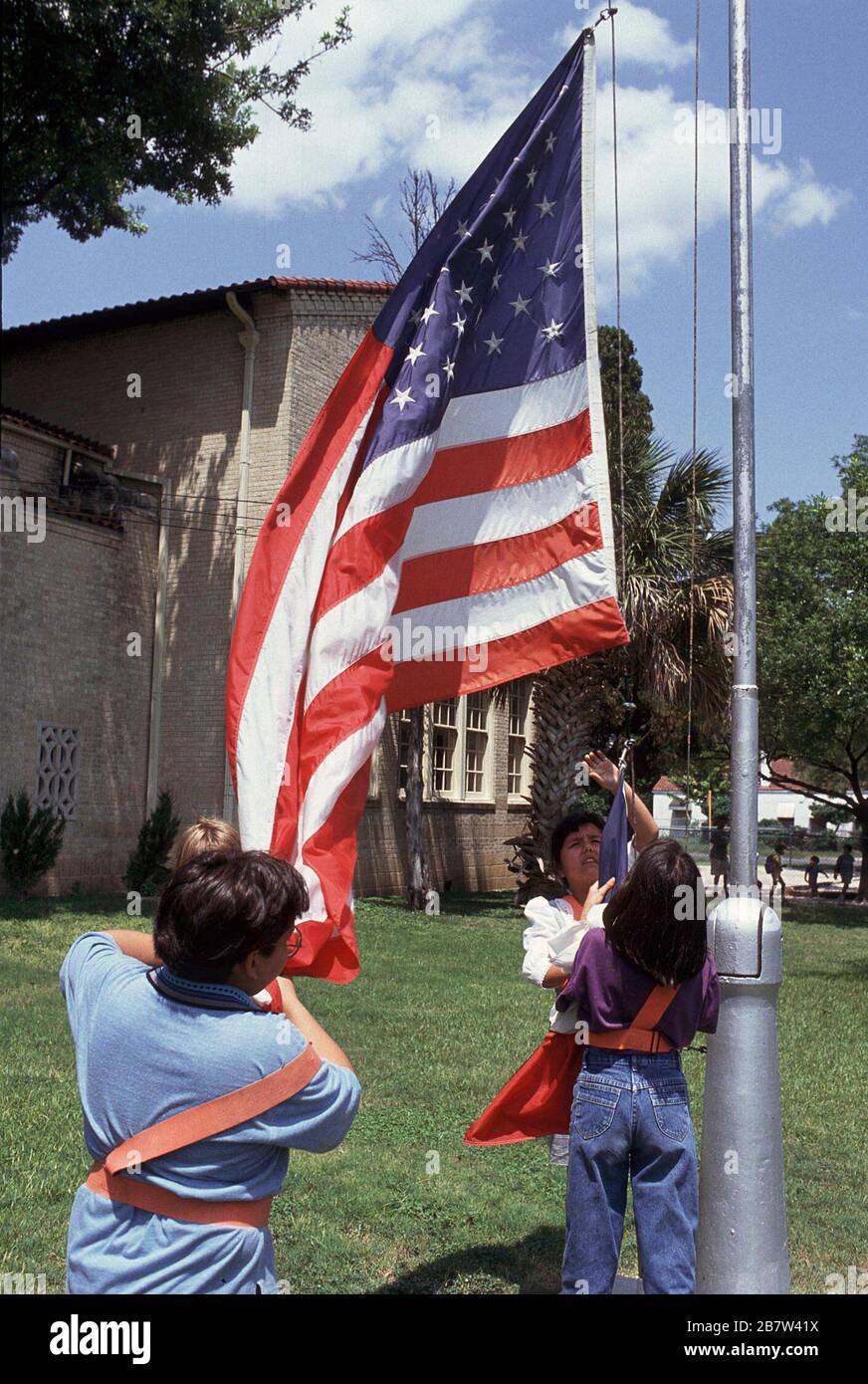 San Antonio, Texas: Children lowering American flag at end of the school day at Woodlawn Elementary School. ©Bob Daemmrich Stock Photo