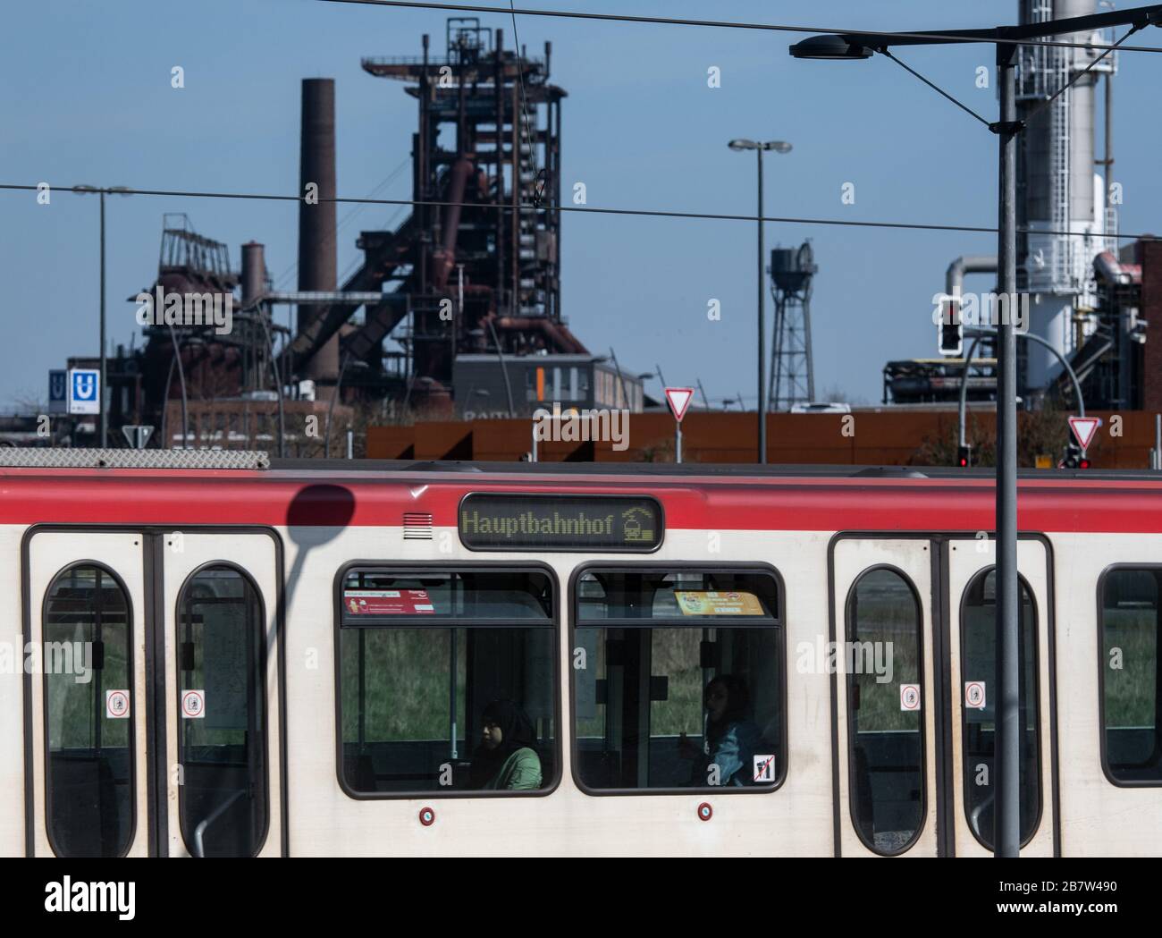 18 March 2020, North Rhine-Westphalia, Dortmund: Few passengers are sitting in a subway that passes the former Phoenix West smelting works and travels towards the main station. Photo: Bernd Thissen/dpa Stock Photo