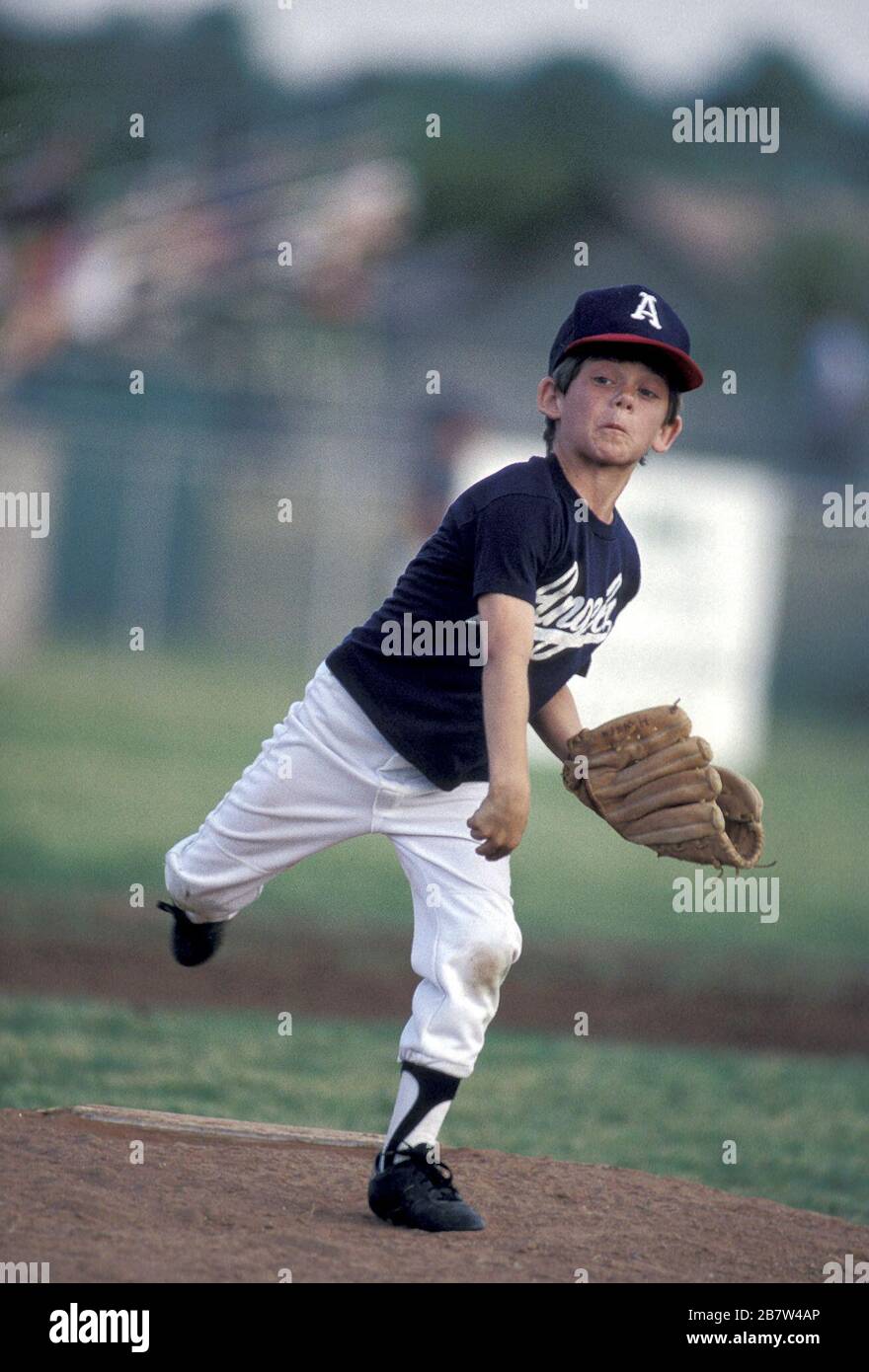 Austin, Texas USA: Young boy pitches during youth league baseball game for 9-11-year-old boys. MR ©Bob Daemmrich Stock Photo
