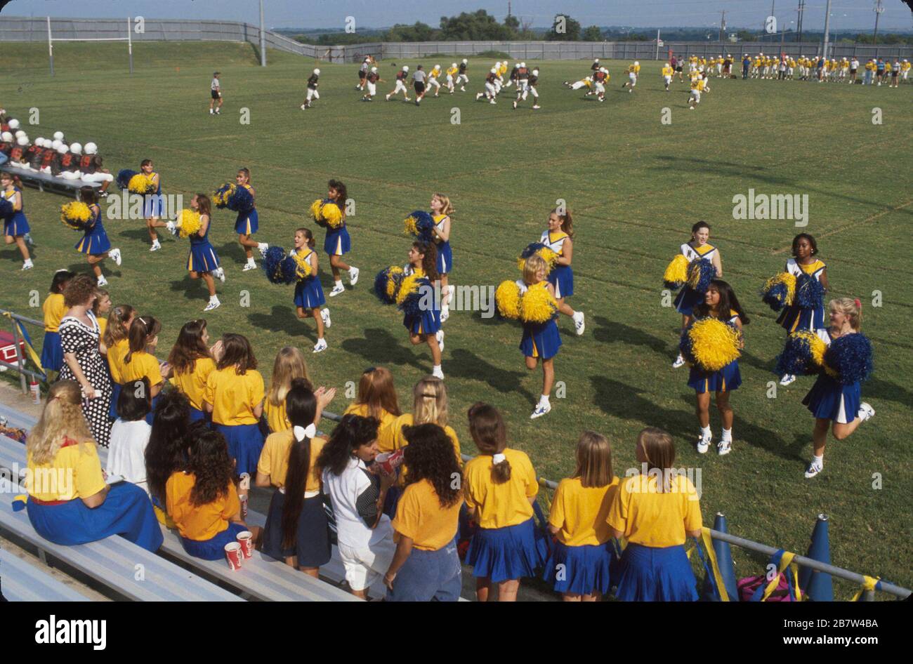 Austin Texas USA: Cheerleaders perform on sideline at junior high school football game. ©Bob Daemmrich Stock Photo