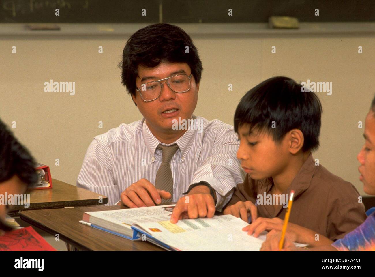 Austin Texas USA: Vietnamese-American student listens to teacher during English as a Second Language class in junior high school.   MR   ©Bob Daemmrich Stock Photo