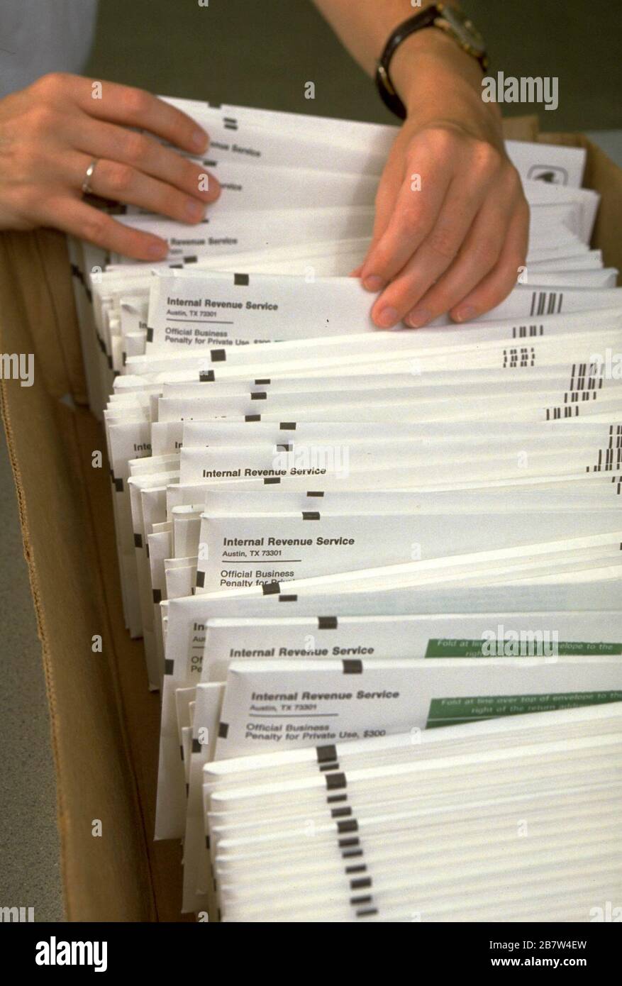 Austin, Texas USA, 1987: Clerk sorts by hand incoming envelopes as Americans mail their tax form to the Internal Revenue Service.  MR   ©Bob Daemmrich Stock Photo