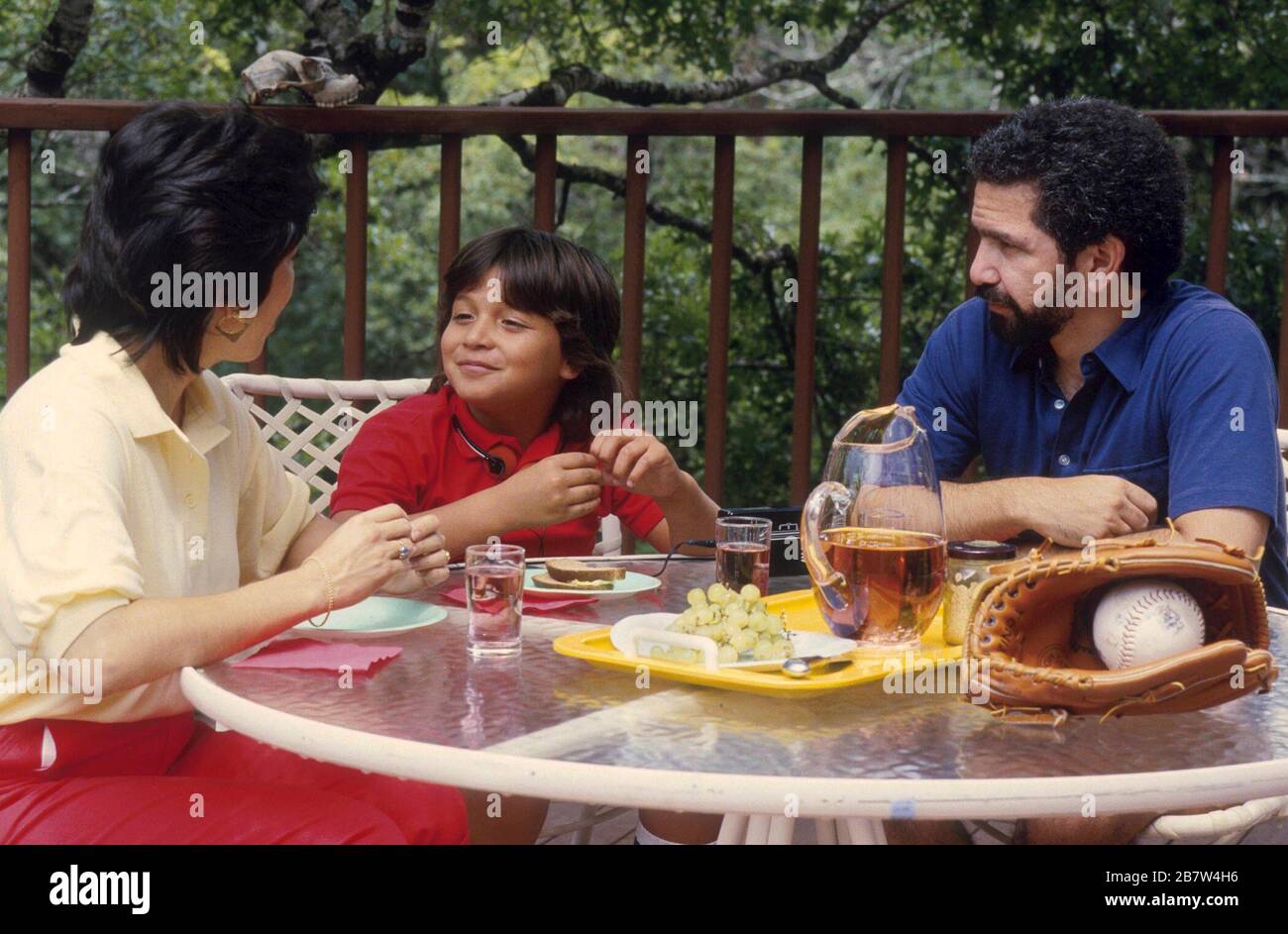 Austin, Texas USA:  Hispanic family eating meal on patio. MR  ©Bob Daemmrich Stock Photo