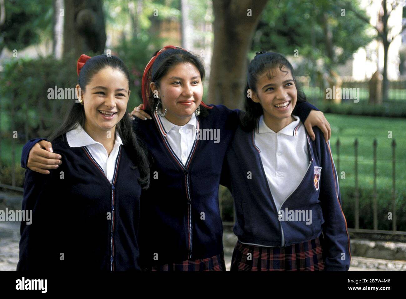 Cuernavaca, Mexico - Three schoolgirls with their arms around each other in front of Cathedral de la Asuncion.  ©Bob Daemmrich Stock Photo