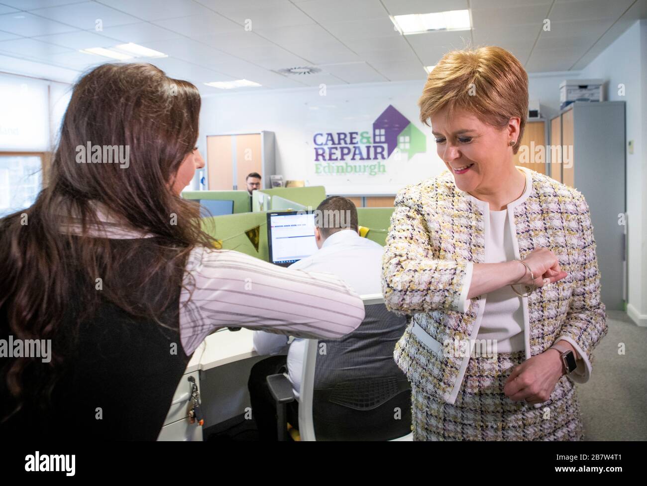First Minister Nicola Sturgeon (right) greets one of the telephonists with an 'elbow bump' during her visit to the Scottish Government-supported Age Scotland helpline in Edinburgh, which is handling calls relating to coronavirus and its impact on the elderly. Stock Photo