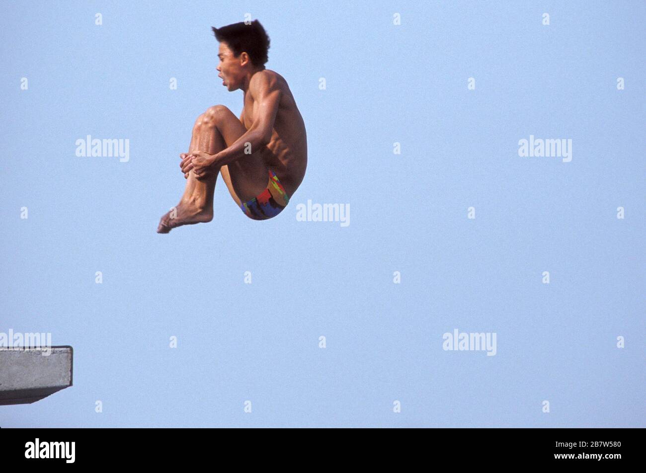 Barcelona, Spain, 1992 Competitor leaps off platform and bends into a