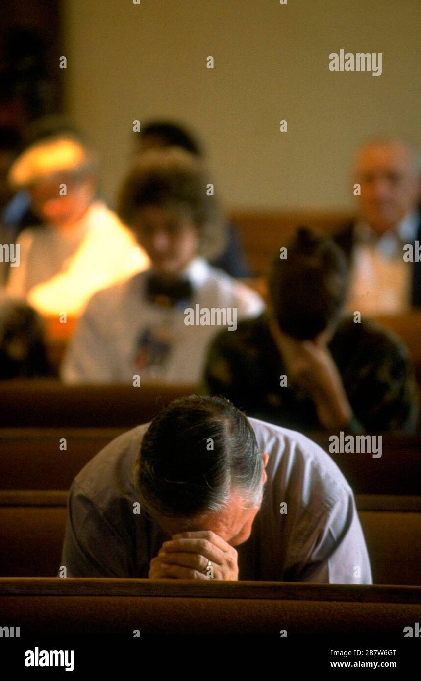 Killeen Texas USA, October 1991: Mourners attend a memorial service for victims of a mass shooting at Luby's Cafeteria in Killeen. on October 16. George Hennard, a 35-year-old Killeen resident, crashed a pickup into the eatery and shot 23 people to death before killing himself. ©Bob Daemmrich Stock Photo