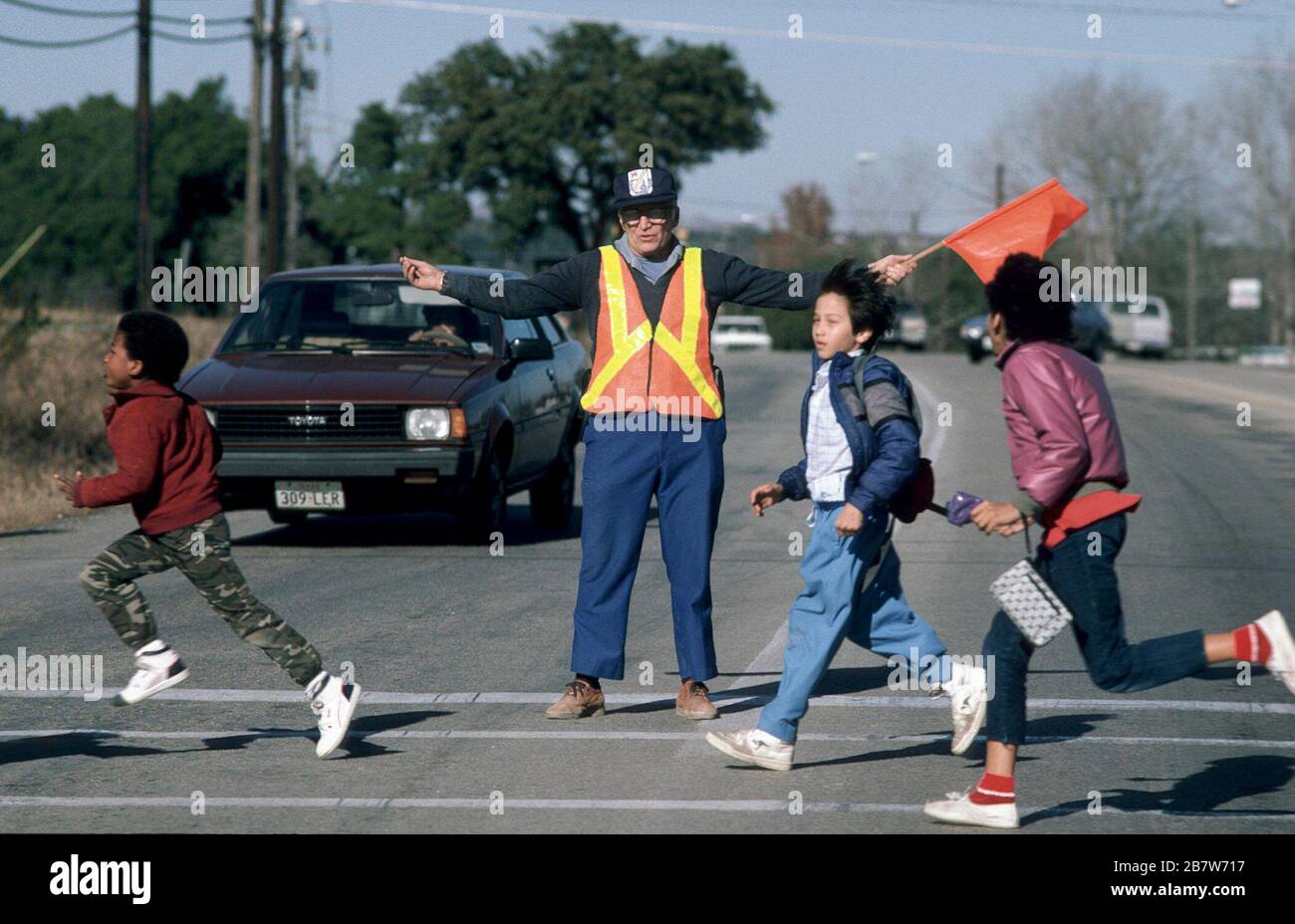 Austin, Texas USA:  Crossing guard at elementary school intersection directs students to cross street safely. . ©Bob Daemmrich Stock Photo