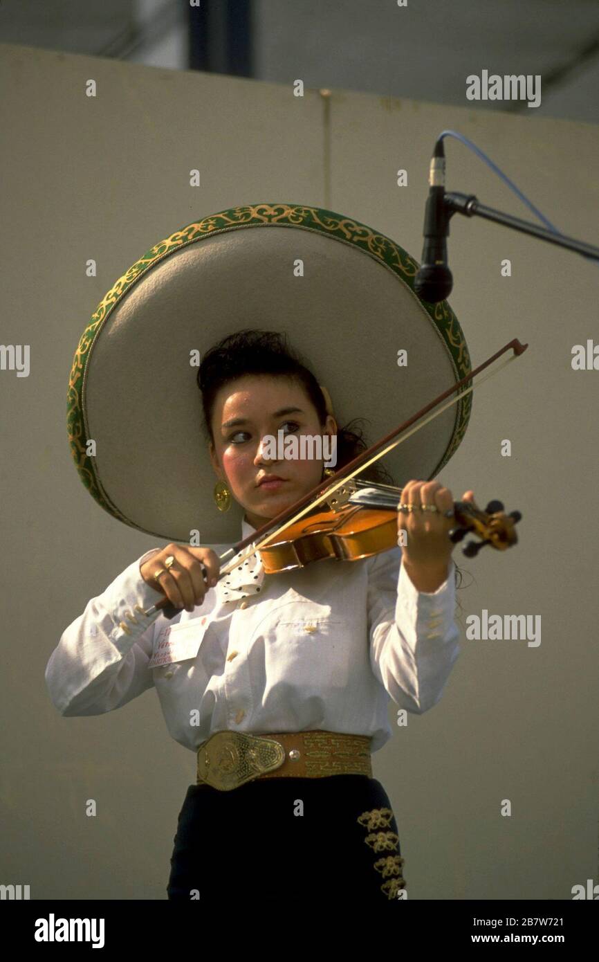 San Antonio Texas USA Female violinist performing in costume with traditional mariachi band at