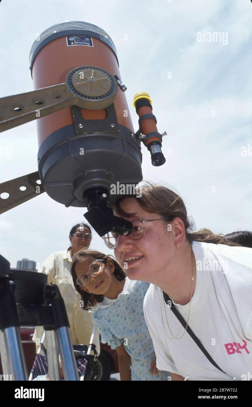 San Antonio Texas USA Woman looks through specialdesigned telescope