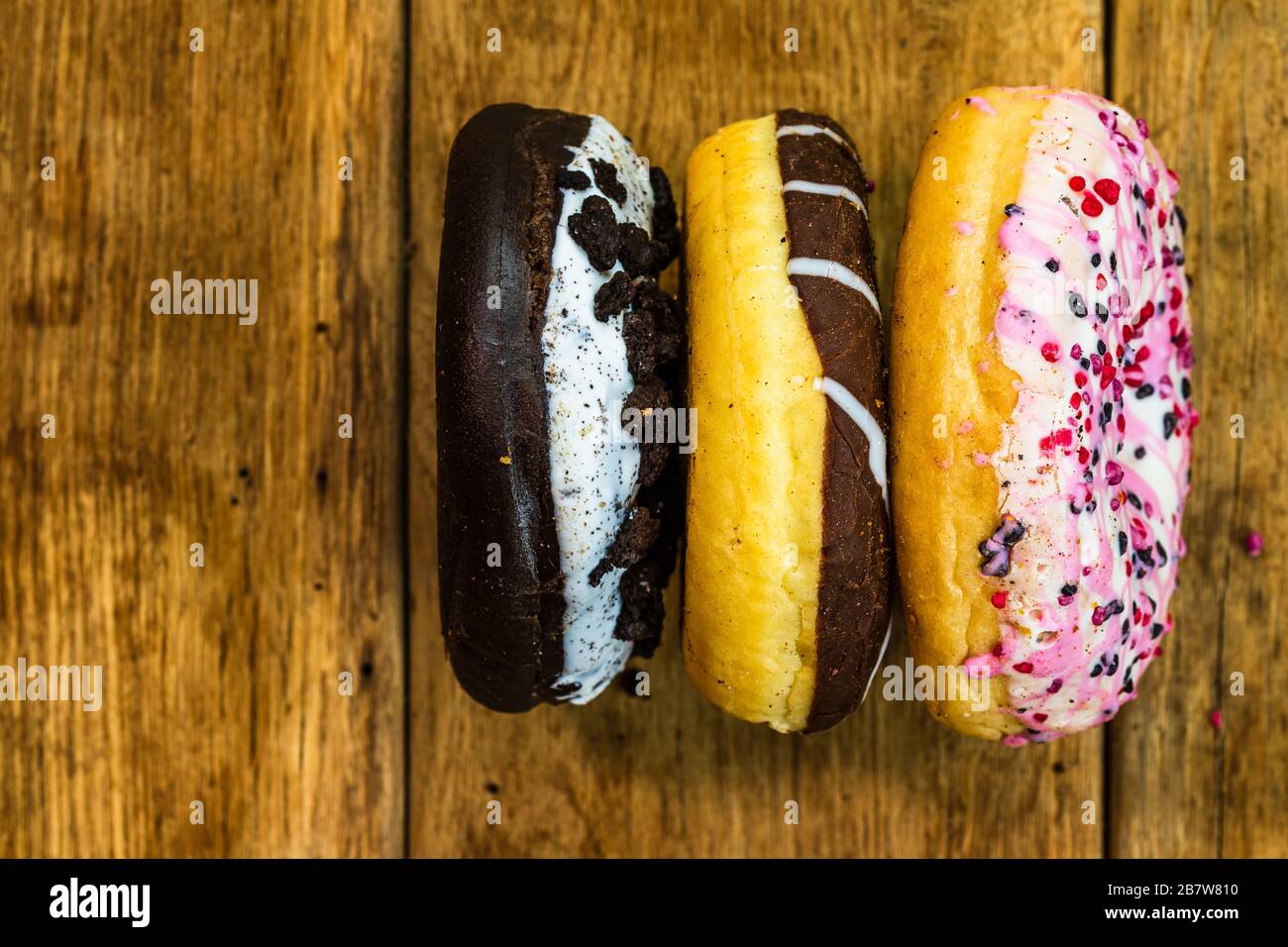 Colorful donuts on table with copy space. Top view of glazed doughnuts ...