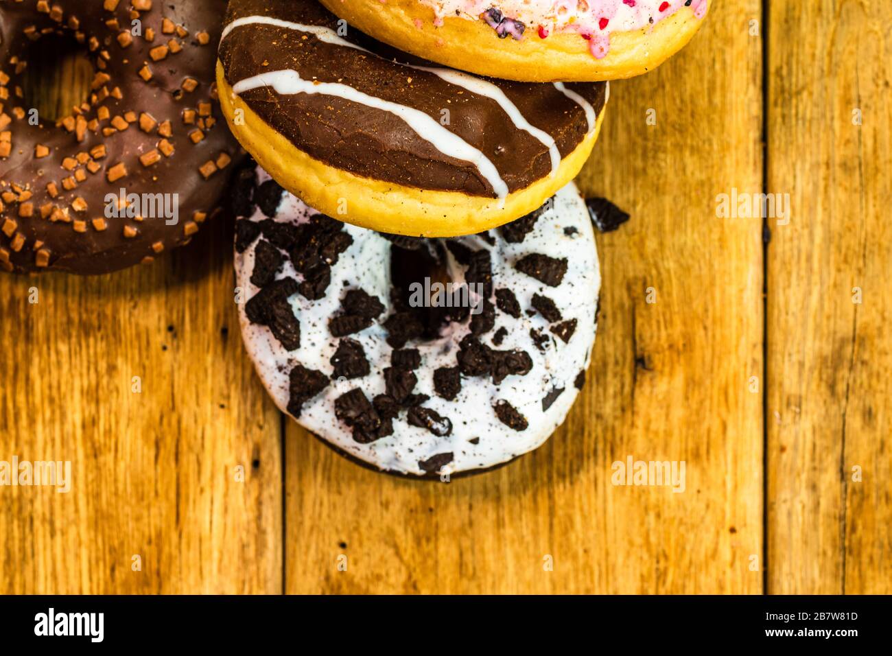 Colorful donuts on table with copy space. Top view of glazed doughnuts ...