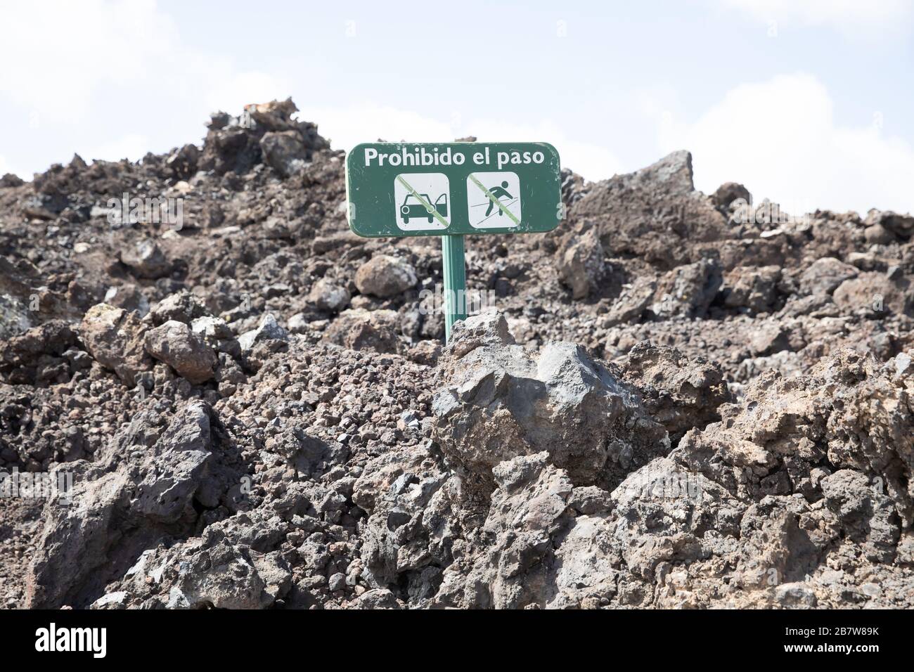 Warning sign to cars and people not to go onto to the Molten volcanic lava rock in Lanzarote, The Canary Islands Stock Photo