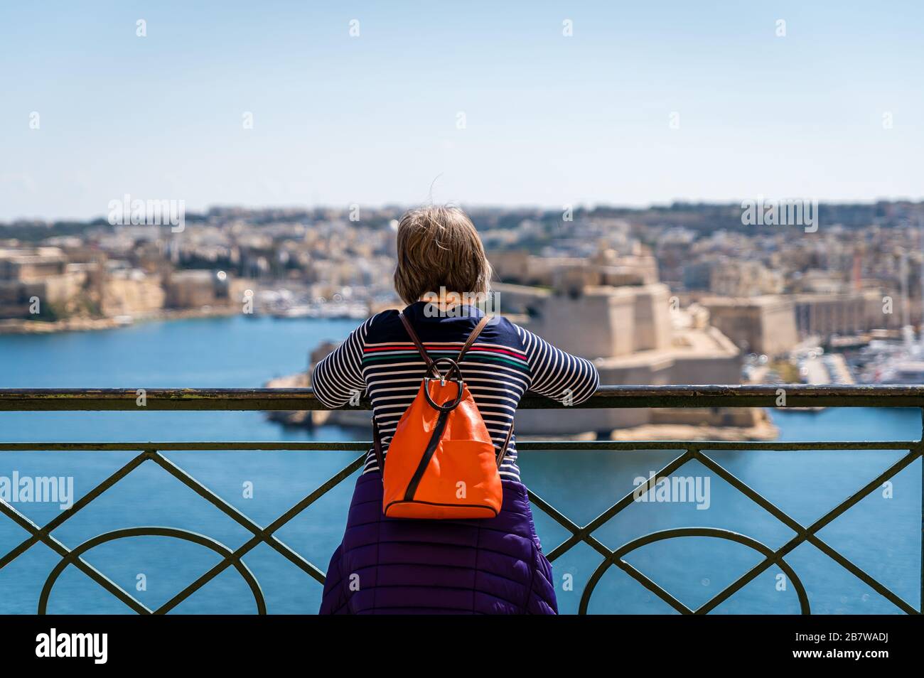 Tourist looking over towards the Three Cities, Malta Stock Photo