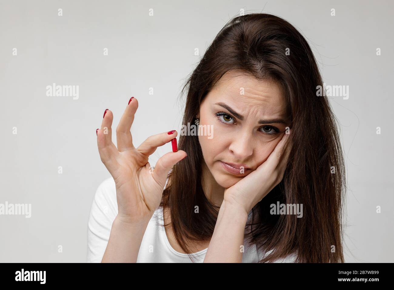 young sad woman with medicine suffering from tooth pain, caries. girl