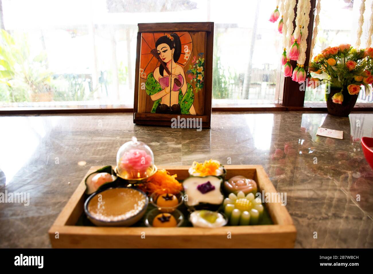 SAMUT SONGKHRAM, THAILAND - OCTOBER 30 : Nine auspicious thai desserts and many sweets snacks thai style for travelers people eating at restaurant caf Stock Photo