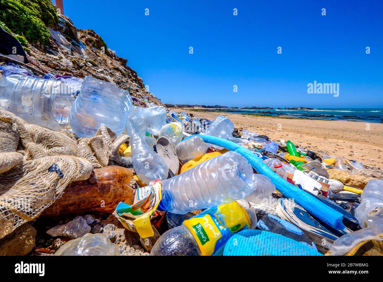 A pile of plastic water bottles and other waste on a Moroccan beach Stock Photo