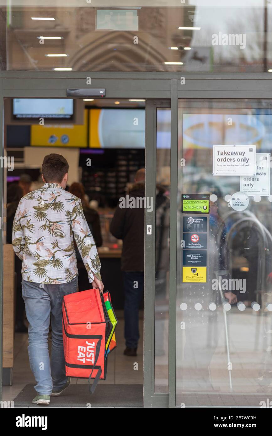 Southend on Sea, Essex, UK. 18th March, 2020. A number of businesses in Southend on Sea are being affected by the situation surrounding COVID-19 in the UK. Food outlets such as McDonalds have become take-away or delivery only. A Just Eat courier entering Stock Photo