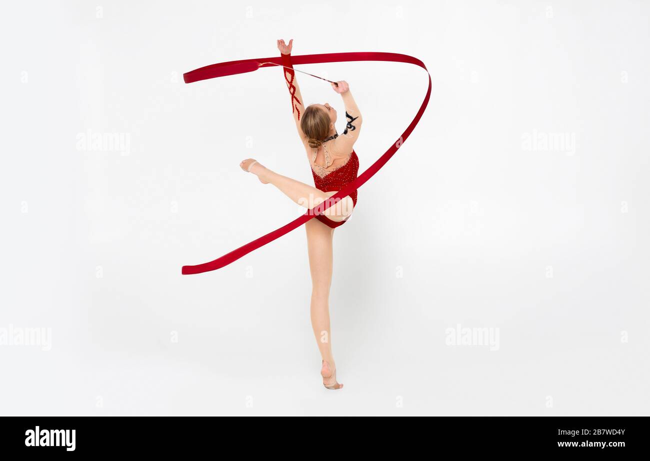 Gymnastics and acrobatics. Professional athlete exercising with ribbon on white background Stock Photo