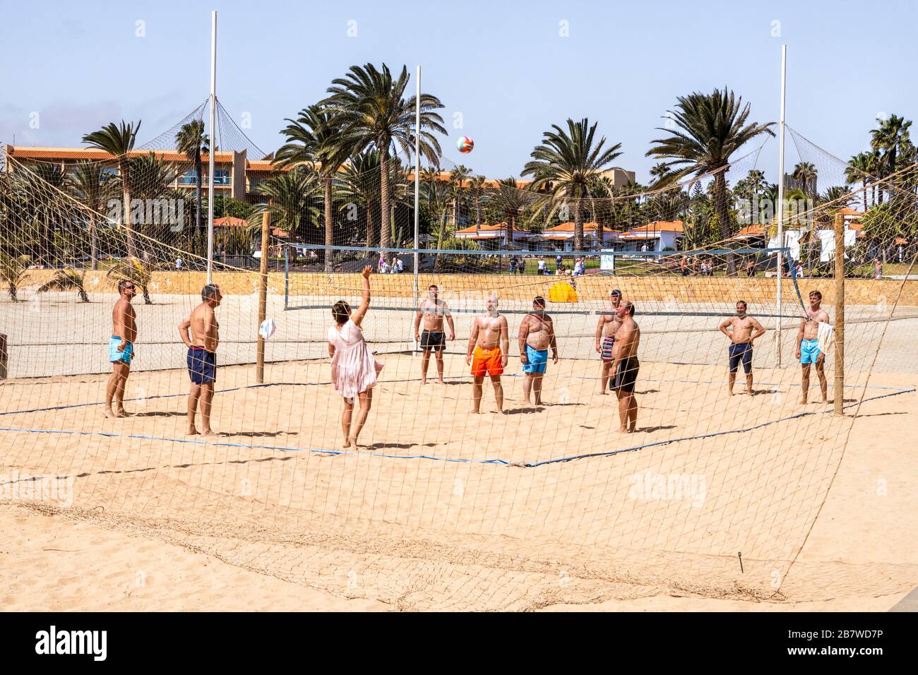 A game of beach volleyball on a Sunday afternoon on the seafront at Caleta de Fuste on the east coast of the Canary Island of Fuerteventura Stock Photo