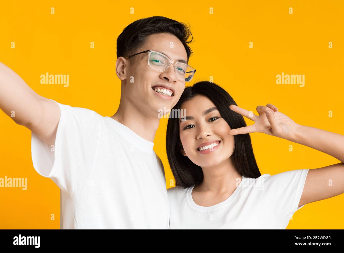 Beautiful asian couple in love smiling while taking selfie Stock Photo ...