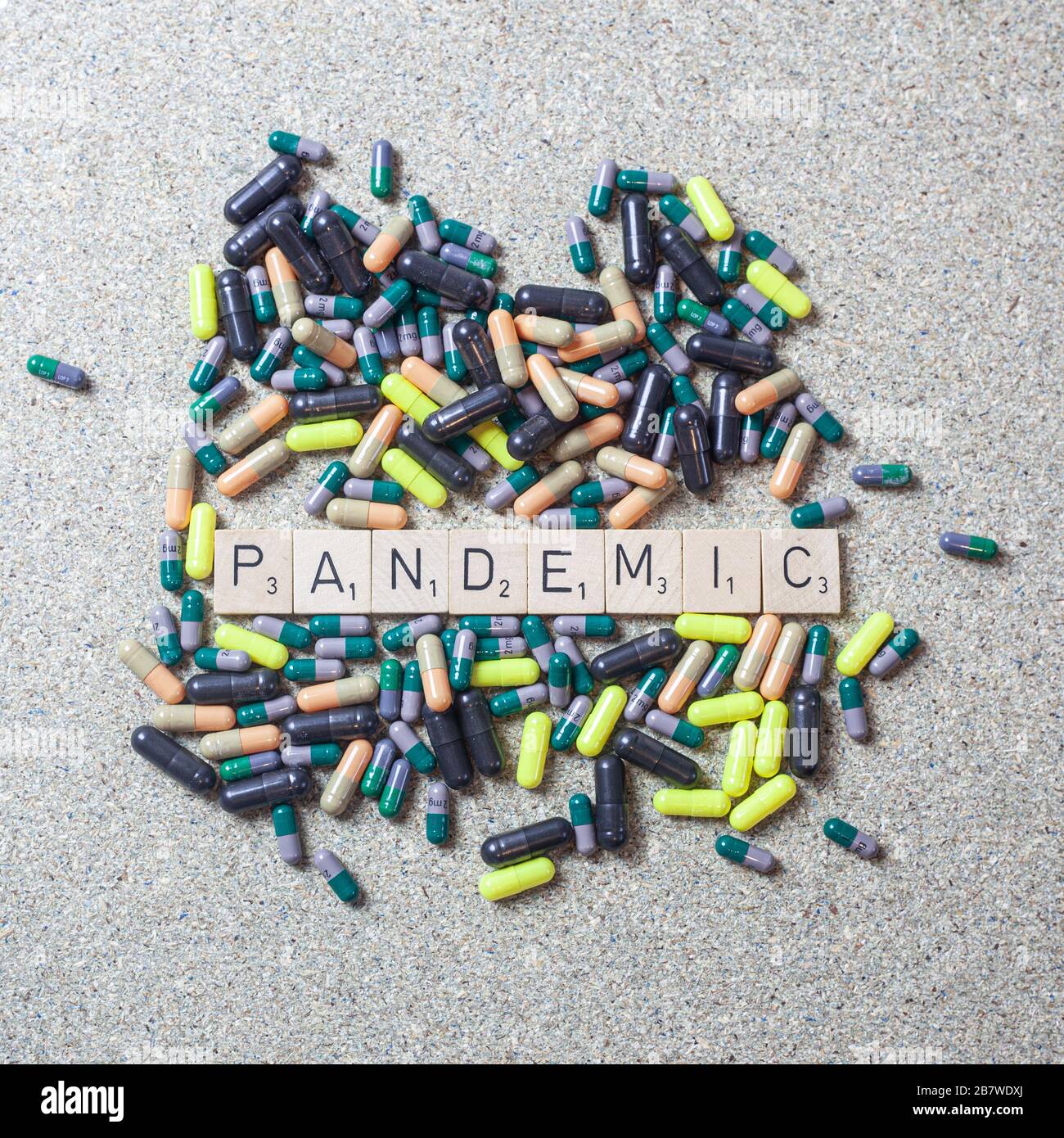 Pandemic in Scrabble letters with pills Stock Photo Alamy
