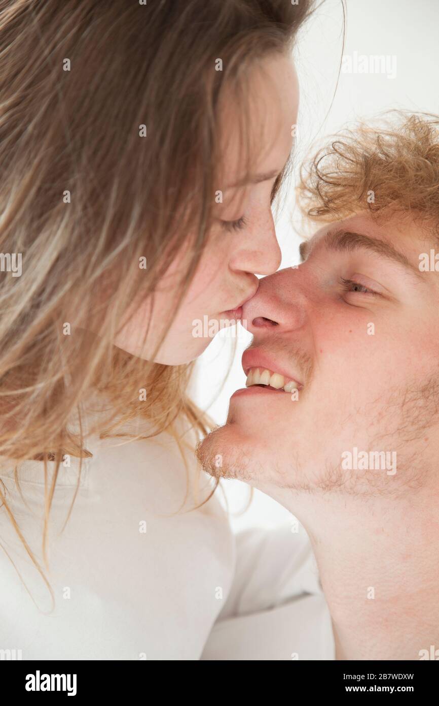 Woman Kissing Man on the Nose, Close-up view Stock Photo