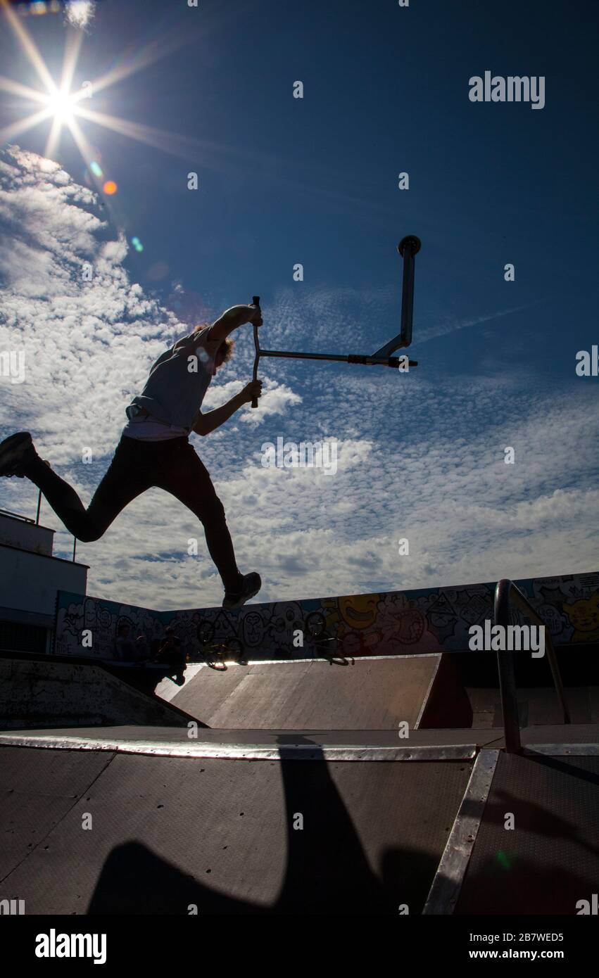 Silhouette of Man Jumping on Ramp at Skate Park Stock Photo