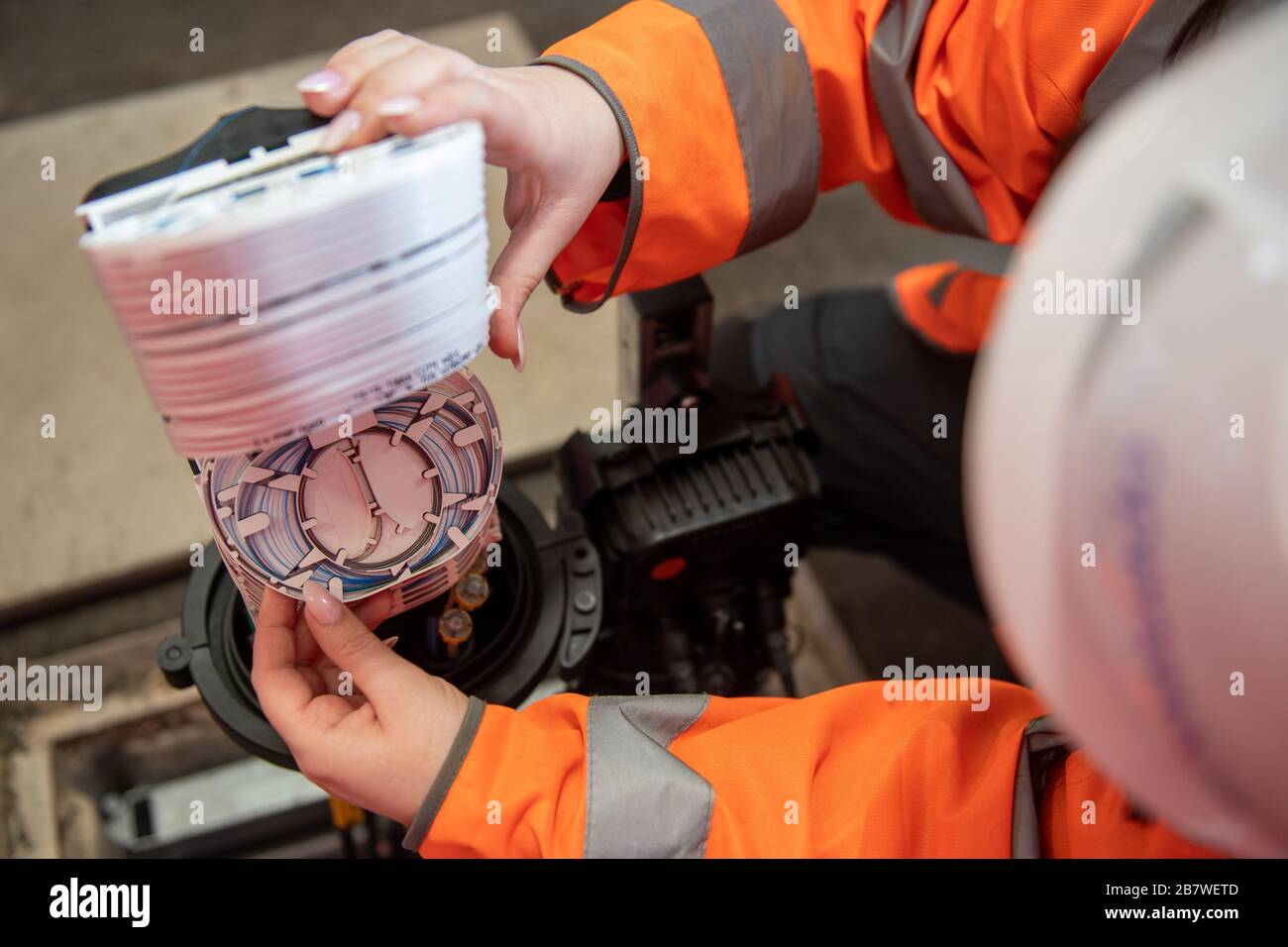 An Openreach engineer inpsecting fibre optic cables at the Openreach