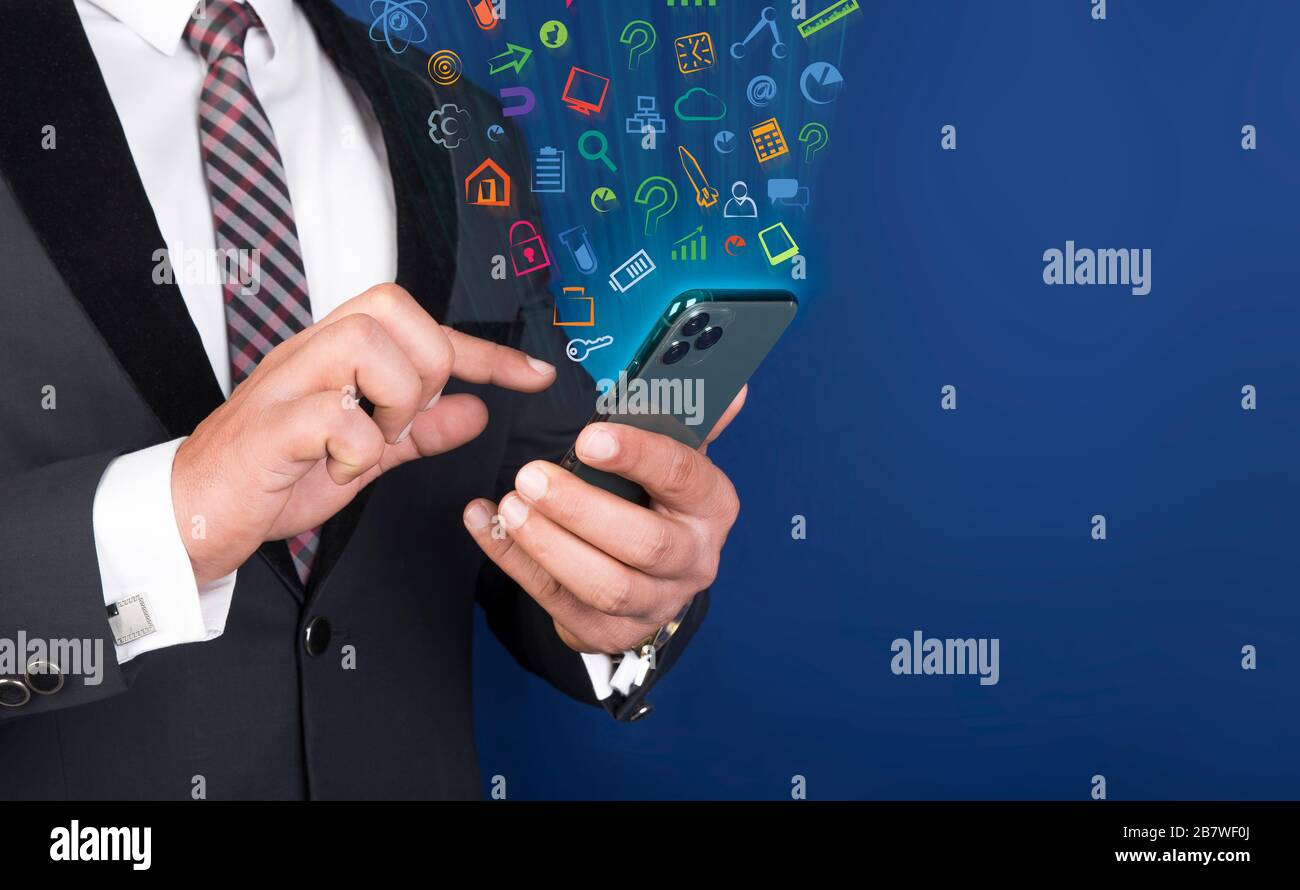 Professional man using smart mobile phone with app icons floating ...