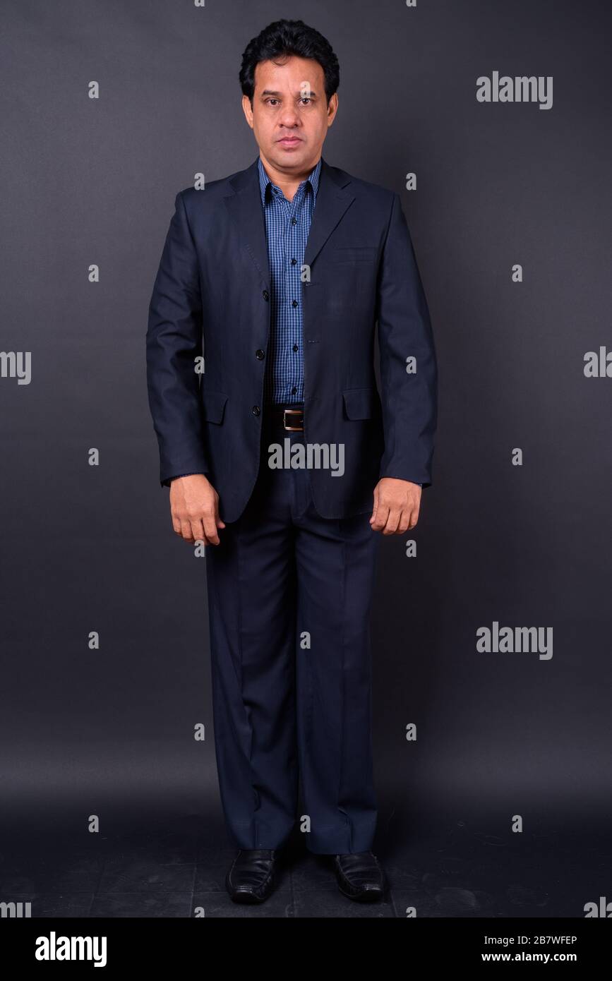 Portrait of mature handsome Indian businessman in suit Stock Photo - Alamy