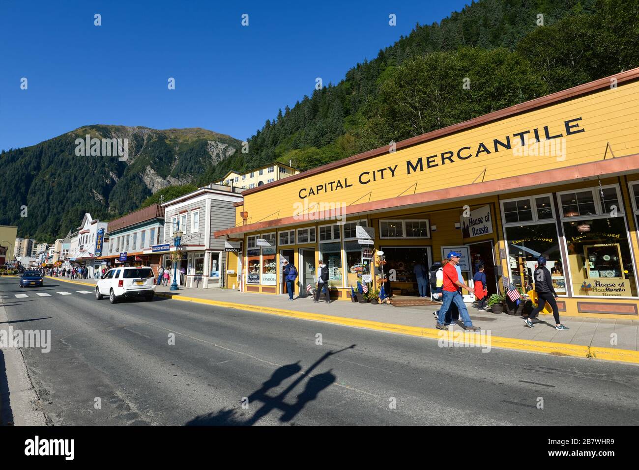 Franklin Street in Juneau Downtown in Alaska, U. Mix of Queen Anne and Russian Colonial architectural style constructions. Sunny day tourists walking. Stock Photo