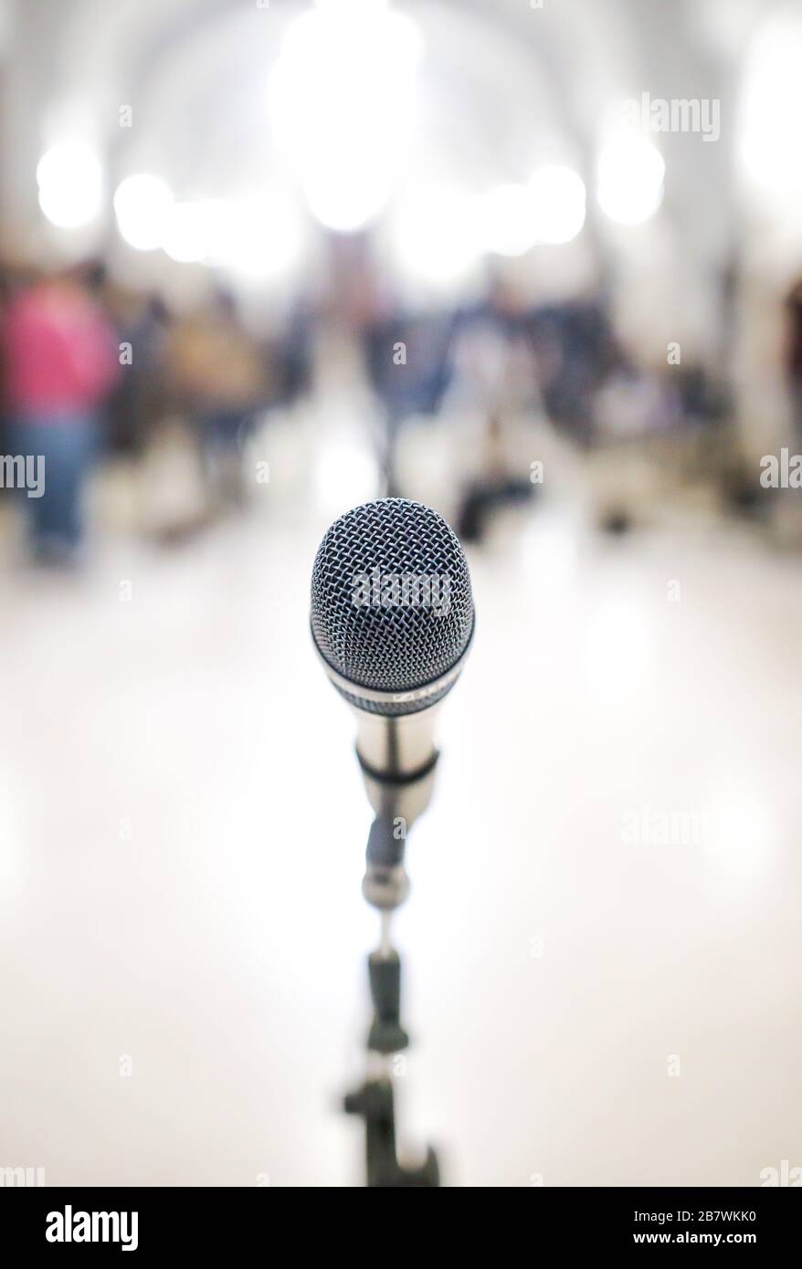 Shallow depth of field (selective focus) image with a microphone in front of TV cameras during a press conference. Stock Photo