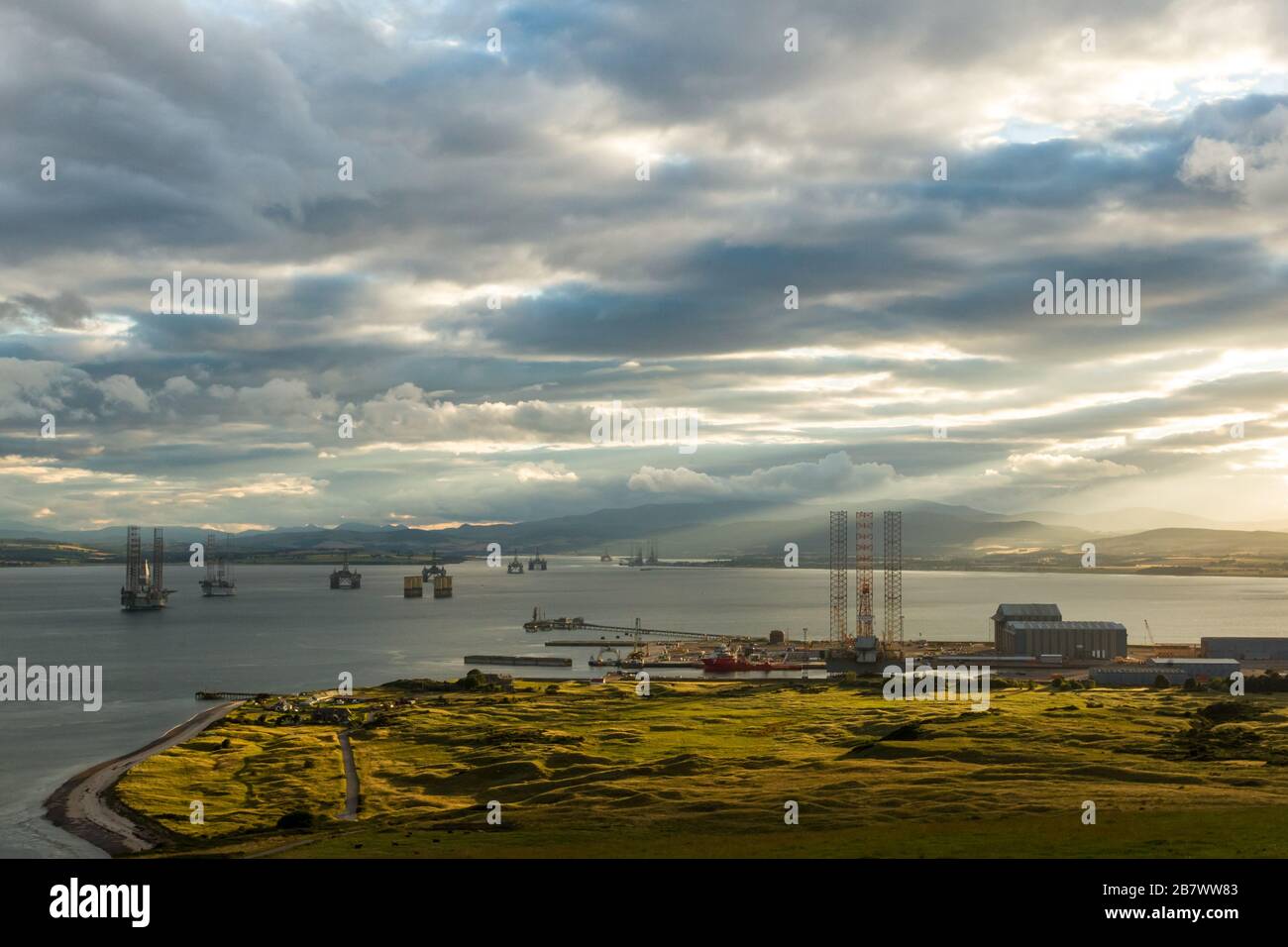 Cromarty Firth on the east coast of Scotland from Nigg Hill. Showing the Nigg fabrication yard and Oil and gas platforms anchored in the Firth Stock Photo
