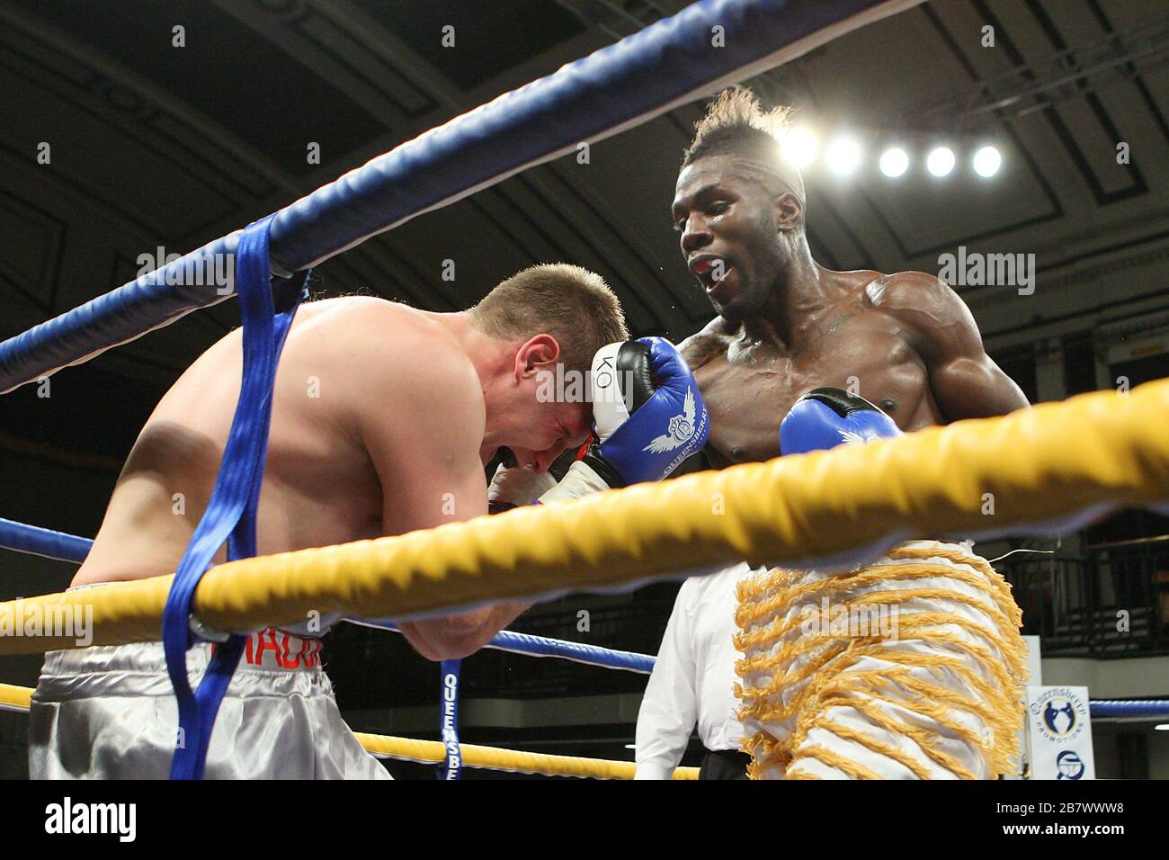 Menay Edwards (gold shorts) defeats Billy Boyle in a Light-Heavyweight ...