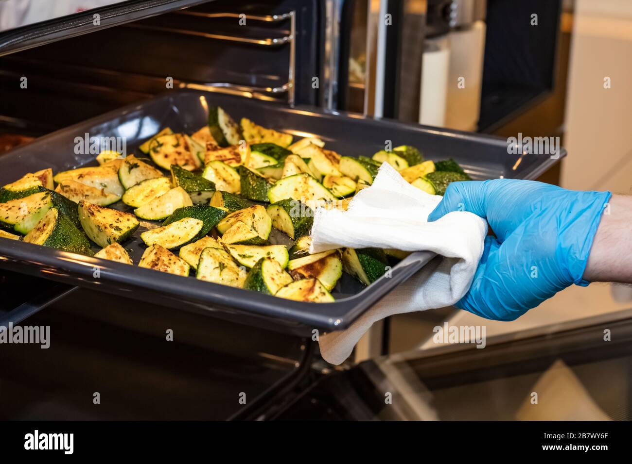 Hand in rubber glove takes hi-res stock photography and images - Alamy