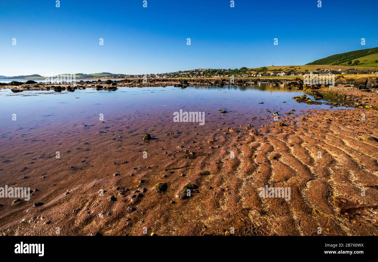 Colorful Firth of Clyde beach at low tide near the picturesque village of Seamill, Scotland in late afternoon on a clear summer day. Stock Photo