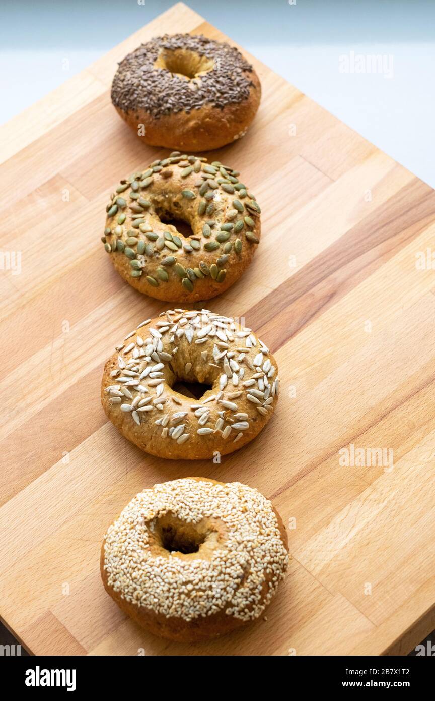 A selection of fresh, homemade seeded bagels Stock Photo