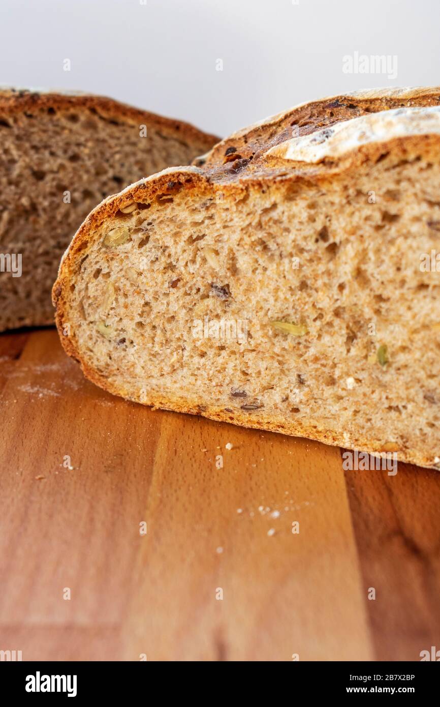 Freshly baked loaf of bread cut in half to reveal the multigrains