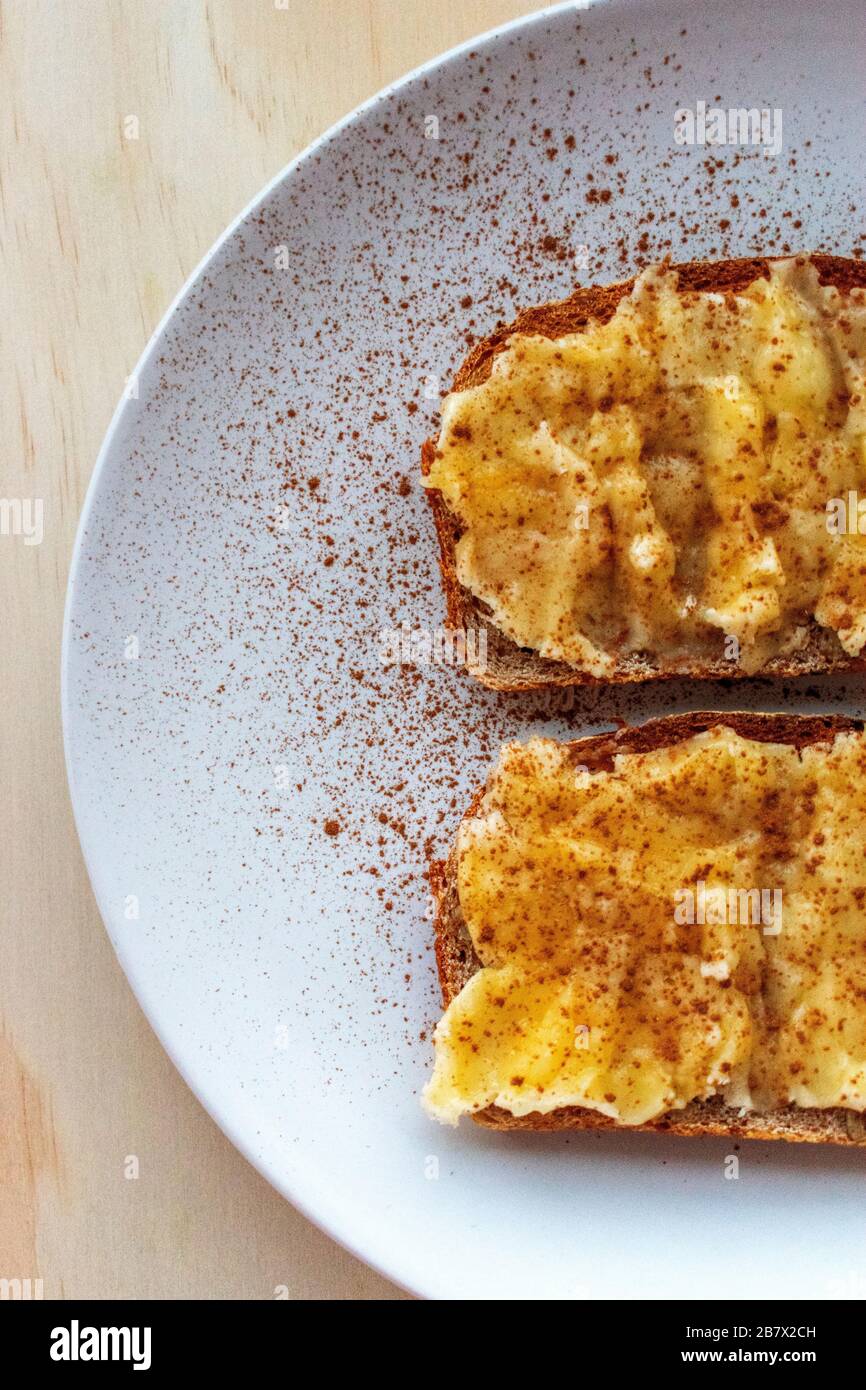 2 slices of banana and cinnamon toast on a plate Stock Photo