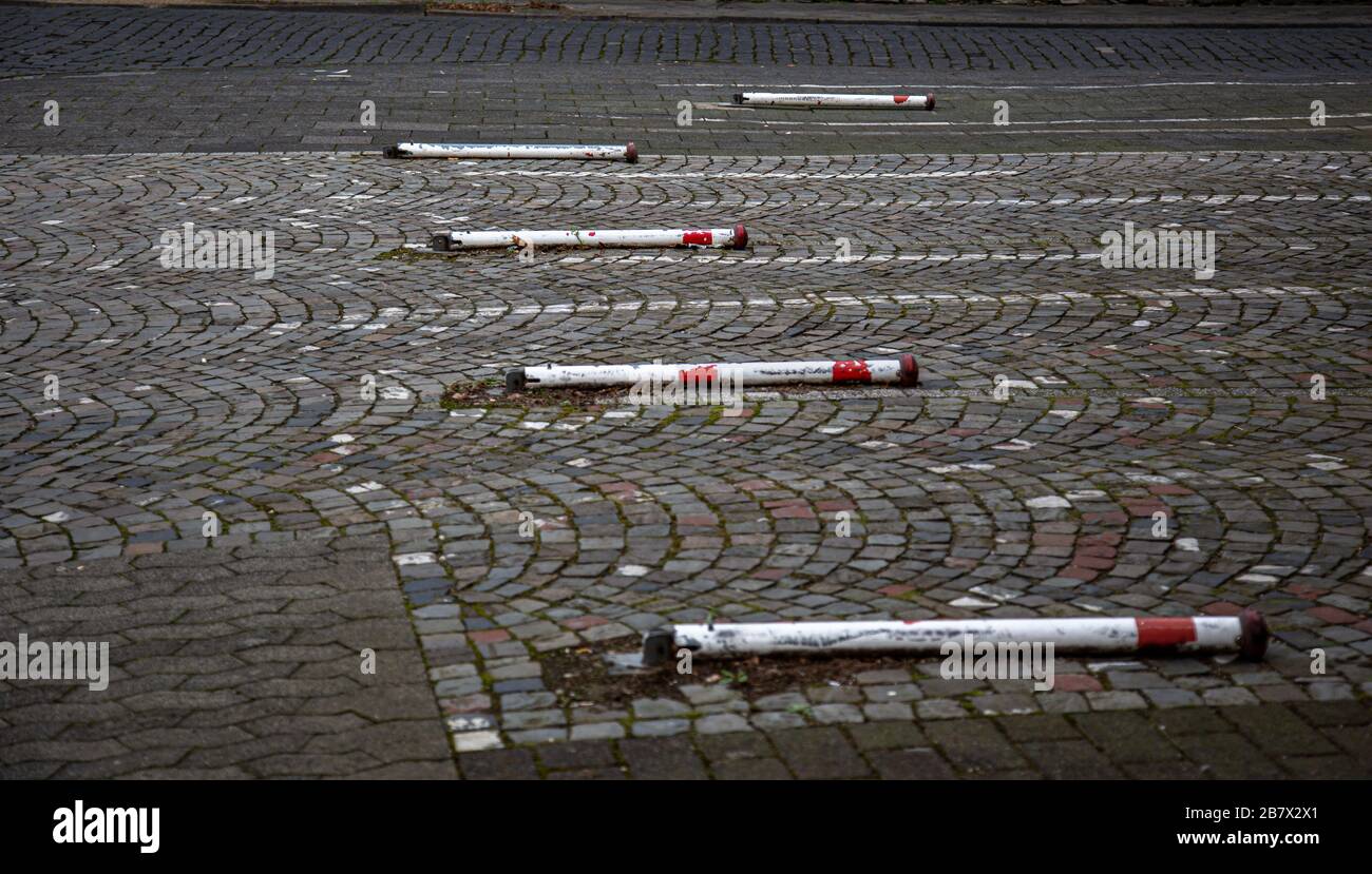 Old poles striped in white and red lying on the ground of park lanes Stock Photo