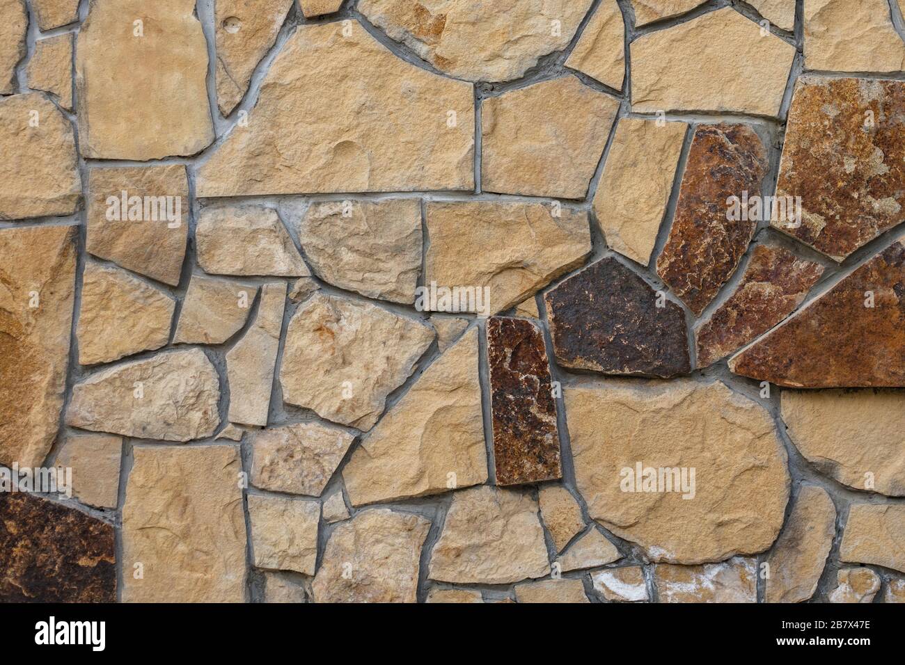 Decorative wall. Rocks texture. Wall of many stones with heterogeneous shapes Stock Photo