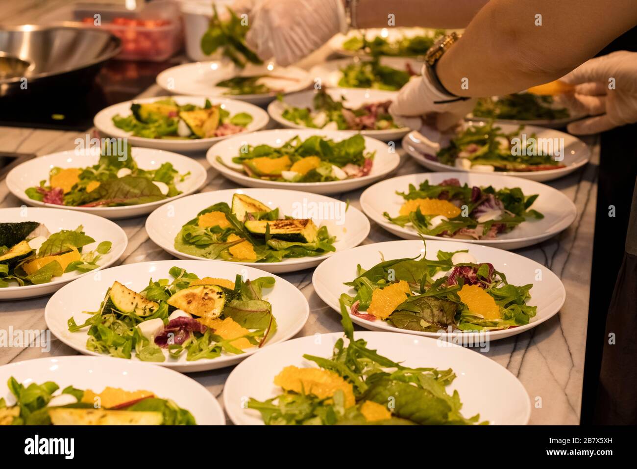 set of dishes of fried zucchini with herbs and soft cheese. Cooking in a restaurant Stock Photo
