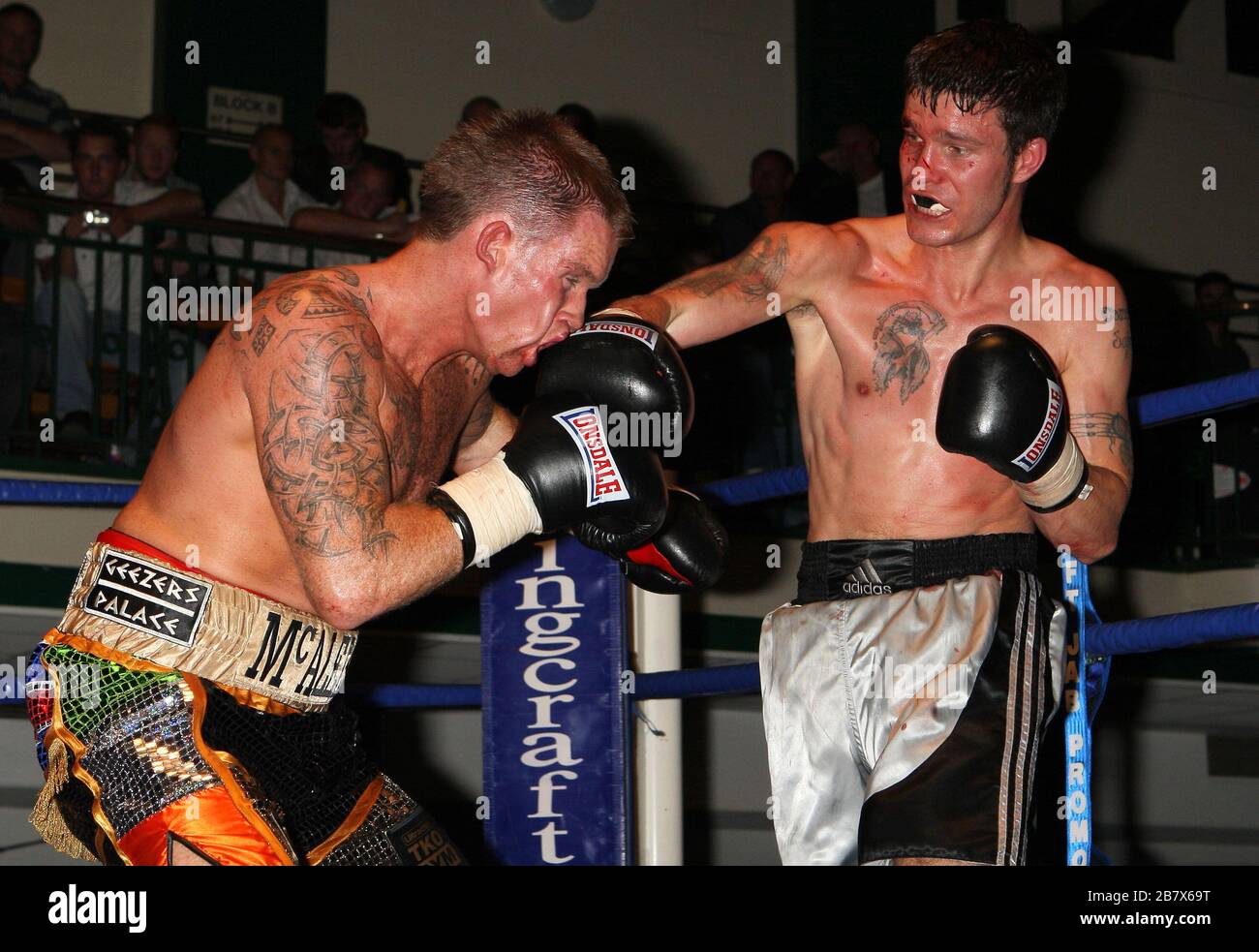 Pat McAleese (multicoloured shorts) defeats Geraint Harvey in a LightMiddleweight boxing