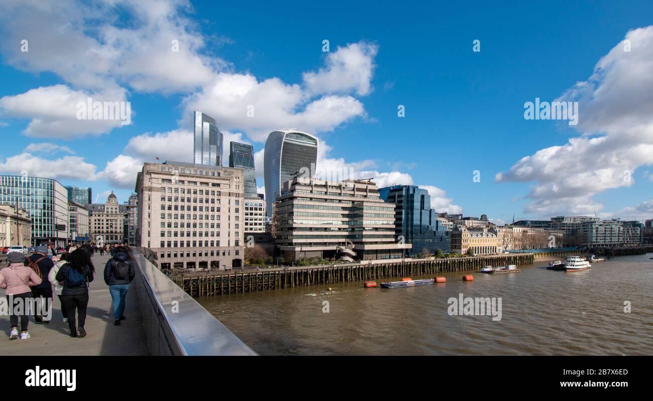 LONDON BRIDGE AND TOURISTS VIEW ACROSS TO BUILDINGS ON LOWER THAMES STREET AND THE WALKIE TALKIE AND CHEESGRATER SKYSCRAPERS Stock Photo