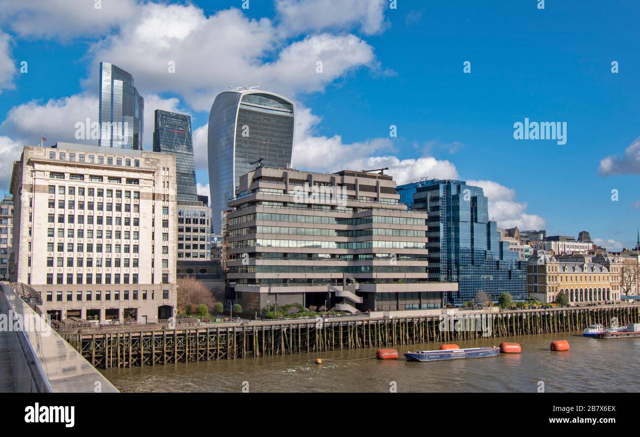 LONDON BRIDGE LOOKING ACROSS TO BUILDINGS ON LOWER THAMES STREET AND THE WALKIE TALKIE AND CHEESGRATER SKYSCRAPERS Stock Photo